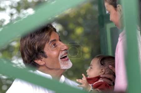 Photo for South Asian Indian Bollywood actor Amitabh Bachchan with a child promoting polio drops - Royalty Free Image