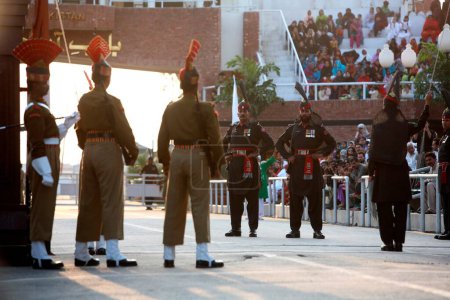 Photo for Indian border security force soldiers and Pakistani  counterpart doing parade before start changing of guard ceremony at Wagah border,  Amritsar, Punjab, India - Royalty Free Image