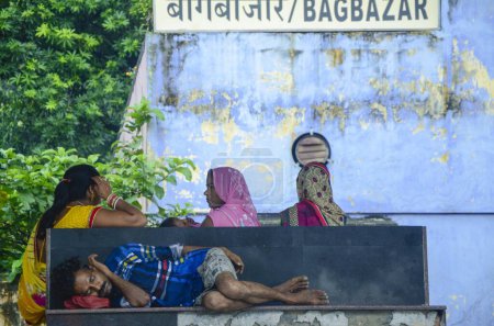 Photo for Man sleeping and women talking, Bagbazar, Kolkata, West Bengal, India - Royalty Free Image