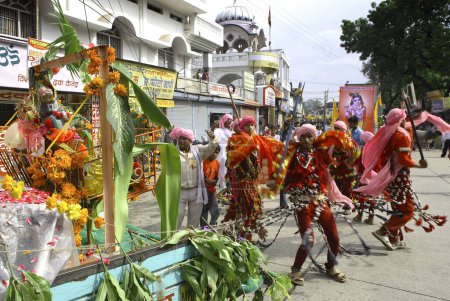 Photo for Janmashtami festival lord Krishna birthday celebration carnival procession with various displays and performances by tribal performing bheel dance, Jabalpur, Madhya Pradesh, India - Royalty Free Image