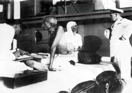 Photo for Mahadev Desai, Mahatma Gandhi, Mirabehn and the captain of SS Rajputana on their sojourn to England, September 1931, India - Royalty Free Image