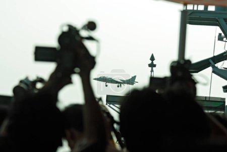 Foto de Videógrafo intenta capturar el desembarco de Harrier, Bombay, Mumbai, Maharashtra, India - Imagen libre de derechos