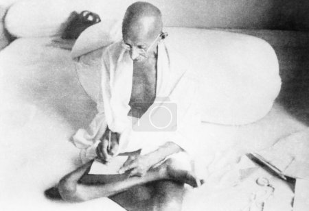 Photo for Mahatma Gandhi writing in New Delhi, 1938, India - Royalty Free Image
