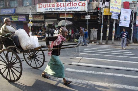 Photo for Man carrying passenger on hand rickshaw at West Bengal India - Royalty Free Image