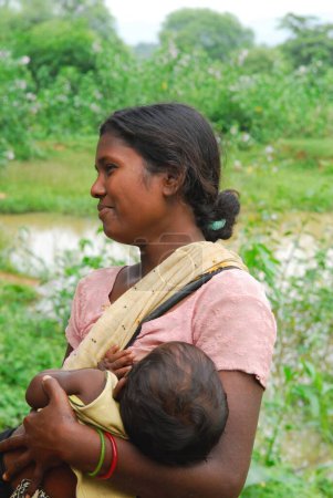 Photo for Ho tribes mother feeding child, Chakradharpur, Jharkhand, India - Royalty Free Image