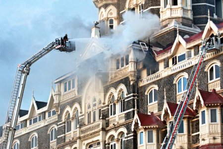 Photo for Fire fighters try to douse fire inside of Taj Mahal hotel after terrorist attack by deccan mujahedeen on 26th November 2008 in Bombay Mumbai, Maharashtra, India - Royalty Free Image