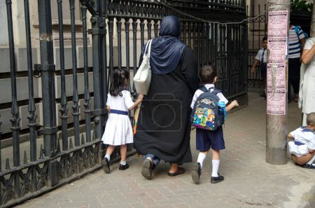 Photo for Muslim woman taking children to school Kolkata West Bengal India Asia - Royalty Free Image