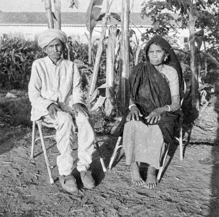 Photo for Old vintage 1900s black and white picture Indian rural couple portrait man woman husband wife wearing sari turban garden India 1940s - Royalty Free Image