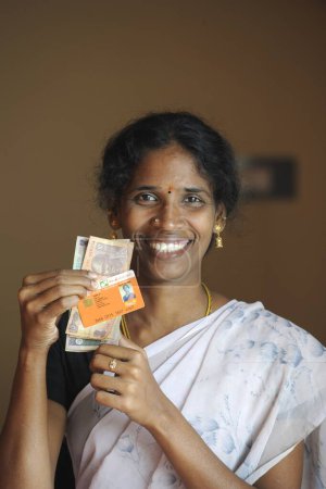 Téléchargez les photos : Dame rurale montrant argent comptant et carte d'identité de la banque par ngo kshtriya gramin services financiers par la fondation IFMR ; Thanjavur ; Tamil Nadu ; Inde NO MR - en image libre de droit