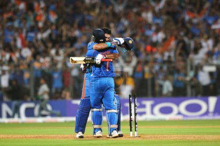Photo for Indian cricket captain Mahendra Singh Dhoni R and team mate Yuvraj Singh celebrate after beating Sri Lanka during the ICC Cricket World Cup 2011 final match at The Wankhede Stadium in Mumbai on April 2 2011 India beat Sri Lanka by six wickets - Royalty Free Image