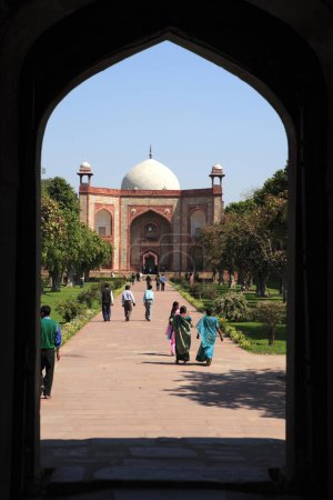 Photo for Humayun's tomb through arch built in 1570 made from red sandstone and white marble first garden-tomb on Indian subcontinent persian influence in mughal architecture , Delhi, India UNESCO World Heritage Site - Royalty Free Image