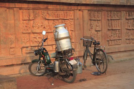 Photo for Milk can on moped and bicycle at Brihadisvara Temple ; Thanjavur ; Tamil Nadu ; India UNESCO World Heritage Site - Royalty Free Image