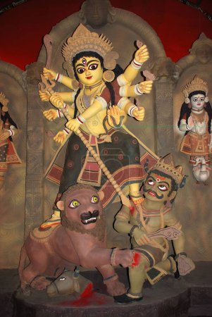 Photo for Decorative Durga clay model standing on lion killing demon mahishasura on Durga puja - Royalty Free Image