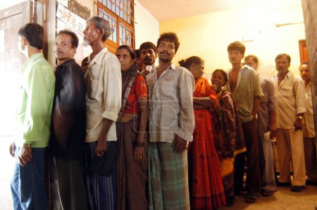 Photo for People standing in a queue to vote during the 2004 Indian Loksabha elections at polling booth at Shivaji Nagar, Govandi, Mumbai Bombay, Maharashtra, India - Royalty Free Image
