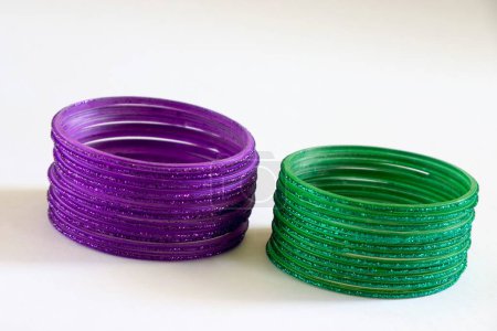 Photo for One dozen twelve round purple and green glass bangles on white background - Royalty Free Image