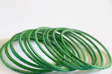 Photo for Eleven round green glass bangles on white background - Royalty Free Image