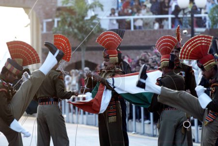 Photo for Indian Border Security Force soldier and Pakistani rangers retreat ceremony called lowering flags at India Pakistan international border, Wagah border, Attari, Punjab, India - Royalty Free Image