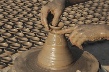 Photo for Potter making pottery on wheel ; Jodhpur ; Rajasthan ; India - Royalty Free Image