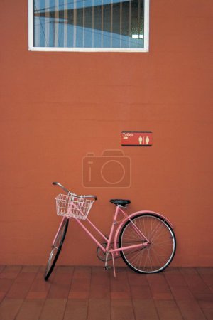 Photo for Bicycle at wall with toilet sign ; Ayers rock Central; Australia - Royalty Free Image