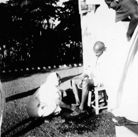 Photo for Kasturba Gandhi washing Mahatma Gandhis feet at Bardoli, 1939, India - Royalty Free Image