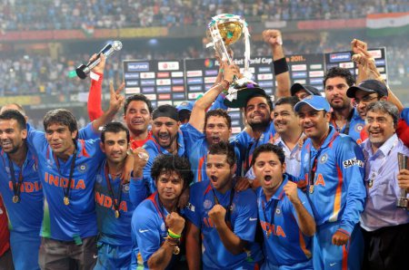 Photo for Indian cricketers celebrate with the ICC World cup trophy after beating Sri Lanka in the ICC Cricket World Cup 2011 final match at The Wankhede Stadium in Mumbai on April 2 2011 India defeated Sri Lanka by six wickets - Royalty Free Image