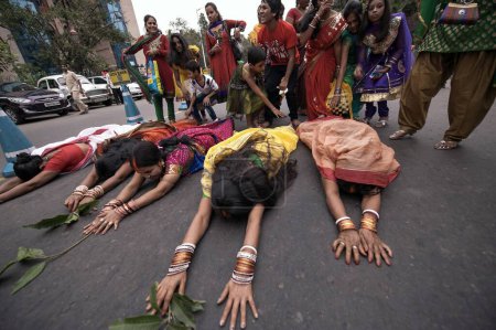 Photo for Woman lying on the road Chhat worship Babughat kolkata India Asia - Royalty Free Image