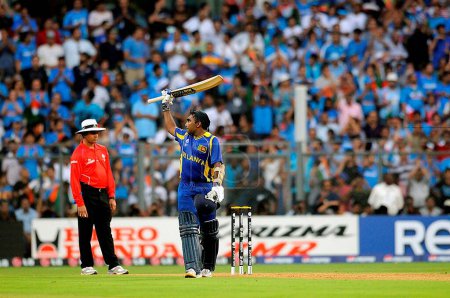 Photo for Sri Lankan batsman Mahela Jaywerdena celebrates after reaching century during the ICC Cricket World Cup finals against India played at the Wankhede stadium in Mumbai India on April 02 2011 - Royalty Free Image