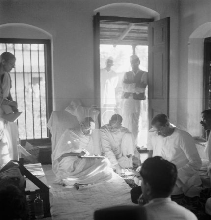 Photo for Mahatma Gandhi in a meeting at Khadi Pratishthan. Sodepur. 24 Parganas. Calcutta. 1946. G.D. Birla . India - Royalty Free Image