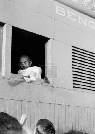 Photo for Mahatma Gandhi, collecting donations for Harijan Fund through his window of the train, 1941 - Royalty Free Image