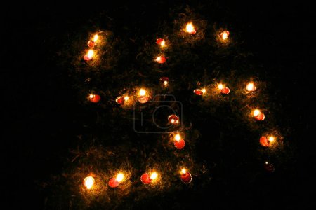 Lighting of oil lamps called Divas in swastik shape on the occasion of Diwali deepawali Festival ; Pune; Maharashtra; India 