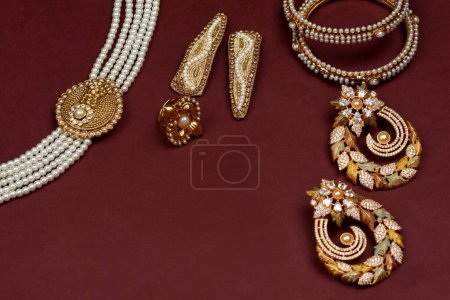 Photo for Pearl Jewelry on a red background, Golden jewellery, Pearl bracelet, pearl hair clip, pearl necklace pearl earrings, finger ring.fashion and design of jewelry. indian traditional jewellery, jewelry background - Royalty Free Image
