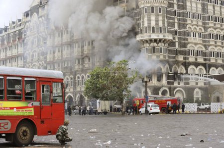 Photo for Fire in old wing of Taj Mahal hotel ; after terrorist attack by Deccan Mujahedeen on 26th November 2008 in Bombay Mumbai ; Maharashtra ; India - Royalty Free Image