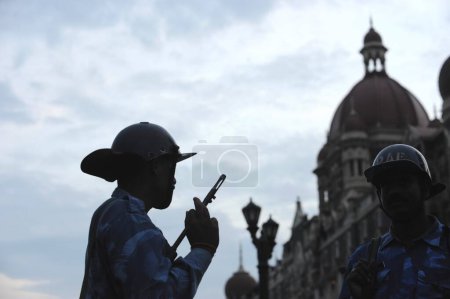 Photo for Rapid Action Force RAF commandos in front of Taj Mahal hotel ; after terrorist attack by Deccan Mujahedeen on 26th November 2008 in Bombay Mumbai ; Maharashtra ; India - Royalty Free Image