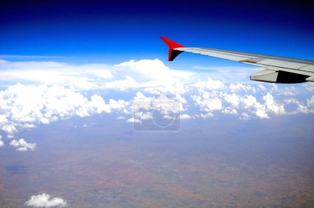 Photo for Aerial view of aeroplane wing in blue sky - Royalty Free Image