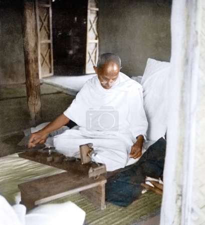 Photo for Mahatma Gandhi spinning in hut, Wardha, Maharashtra, India, Asia, 1939 - Royalty Free Image