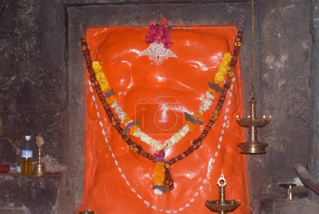 Photo for Idol of Lord Ganesh in scarlet color ; Shri Girijatmaj in Ganesh caves on mountain at Lenyadri ; Ashtavinayak ; Taluka Junnar ; District Pune ; Maharashtra ; India - Royalty Free Image