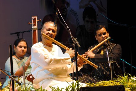 Photo for South Asian Indian Padma bhushan Hari prasad Chaurasia playing flute with his co artist. Mumbai Bombay. Maharashtra. India - Royalty Free Image