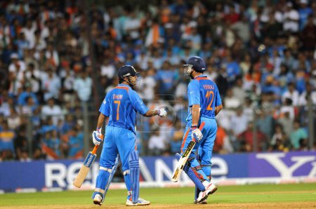 Photo for Indian batsman MS Dhoni Yuvraj Singh during the ICC Cricket World Cup finals against Sri Lanka played at the Wankhede stadium in Mumbai on April 02 2011 - Royalty Free Image