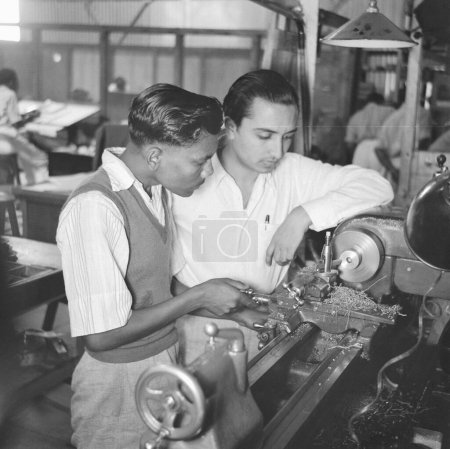 Photo for Men working in the telephone factory, manufacturing of telephone instruments at Bangalore, Karnataka, India, year 1950 - Royalty Free Image