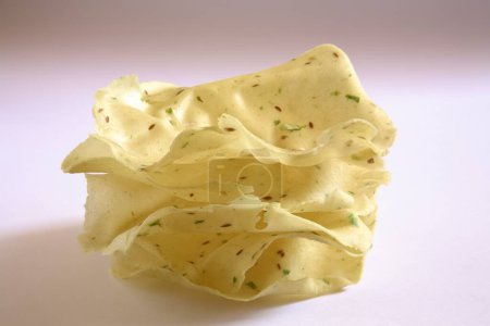 Deep fry papad poppadom made of lentil or cereal flours on white background