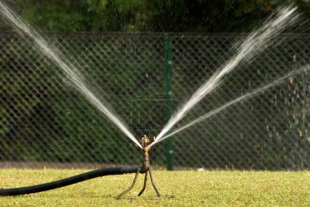Water sprinkler with rotary nozzle at Saras Baug ; Pune ; Maharashtra ; India