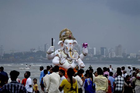 Photo for Ganesh Ganpati festival , people carrying Lord Ganesh idol for immersion at Dadar Beach, Mumbai Bombay, Maharashtra,  India - Royalty Free Image