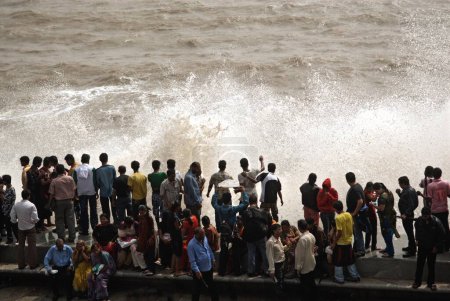 Photo for People enjoying hightide waves at marine drive ; Bombay Mumbai ; Maharashtra ; India  24-July-2009 - Royalty Free Image