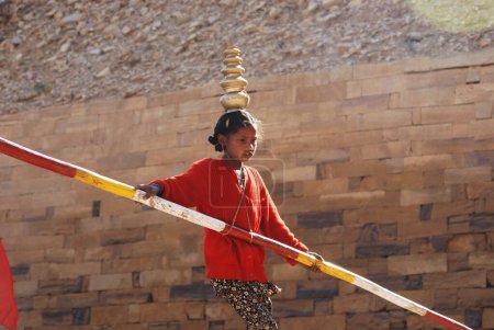 Photo for Girl performing acrobat on rope, Jaisalmer, Rajasthan, India - Royalty Free Image