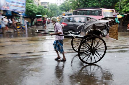 Photo for Man pulling Hand Rickshaw on street in Kolkata at West Bengal India Asia - Royalty Free Image