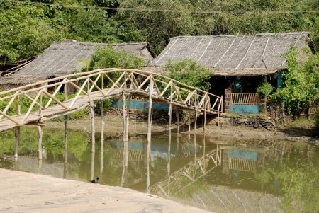 Cabañas con techo de paja conectadas por puente de bambú en la playa de Om; Kumta; Karnataka; India