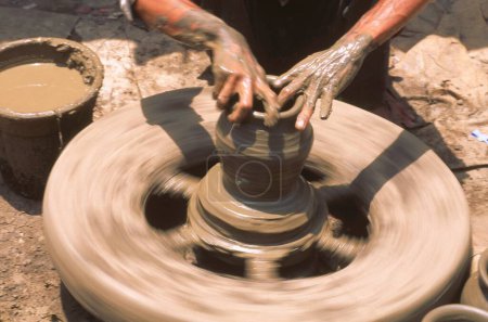 Photo for Pottery , potter hand giving shape to clay pot on wheel , Rajasthan , India - Royalty Free Image