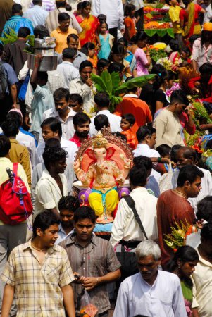 Photo for Arrival procession of idol of lord Ganesh ; Elephant headed god of Hindu ; Ganapati Festival at Dadar market ; Bombay Mumbai ; Maharashtra ; India - Royalty Free Image
