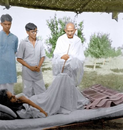 Photo for Mahatma Gandhi talking to Kunvarji Parekh resting, Wardha, Maharashtra, India, Asia, 1941 - Royalty Free Image