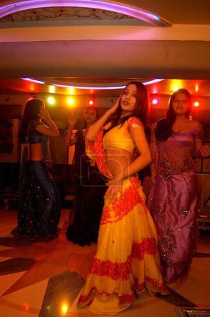Photo for Decked up girls dancing in bar, Bombay Mumbai, Maharashtra, India - Royalty Free Image